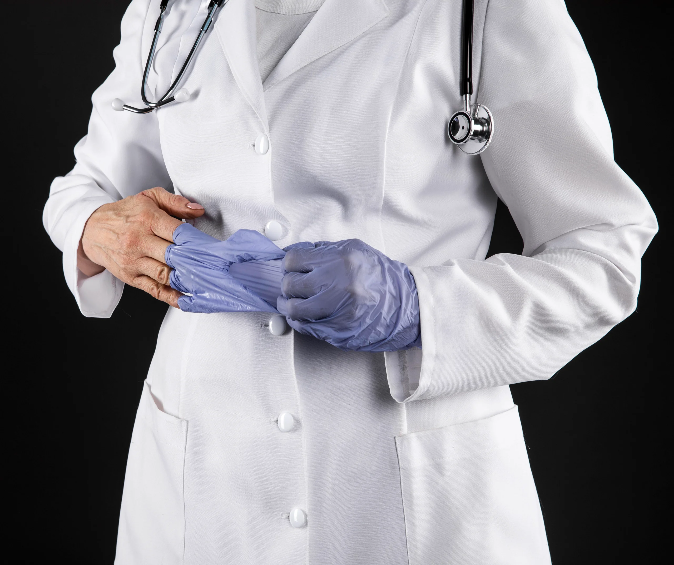 this image shows a plastic surgeon with his white coat and gloves